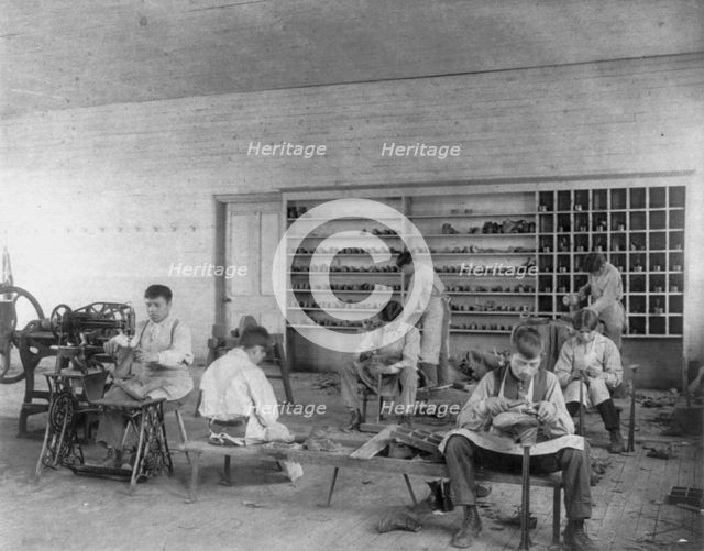 Classroom scenes at Carlisle, Pa., Indian School. Shoe making and repairing; male students, 1901. Creator: Frances Benjamin Johnston.