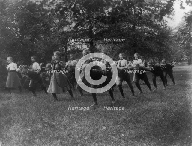 Classroom scenes in Washington, D.C. public schools - outdoor exercise with rods..., (1899?). Creator: Frances Benjamin Johnston.