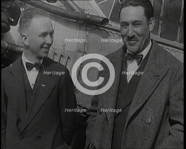 Clarence Duncan Chamberlin And Bertrand Blanchard Acosta Talking in Front of an Airplane, 1920s. Creator: British Pathe Ltd.