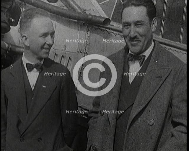 Clarence Duncan Chamberlin And Bertrand Blanchard Acosta Talking in Front of an Airplane, 1920s. Creator: British Pathe Ltd.