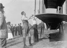 Claude Grahame-White - Fixing Wing of His Forman Plane, 1910. Creator: Harris & Ewing