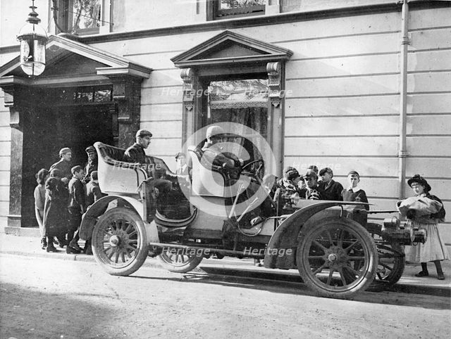 Claude Johnson behind the wheel of a 1905 Rolls-Royce 20hp. Creator: Unknown.