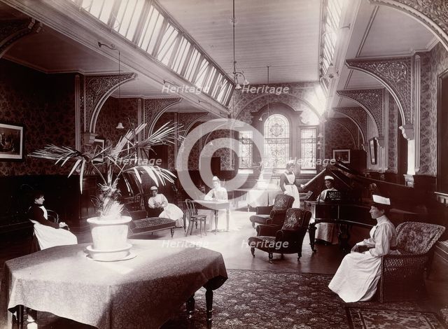 Claybury Asylum, Woodford, Essex: a nurses' day-room (?), (1893?). Creator: London & County Photographic Co.