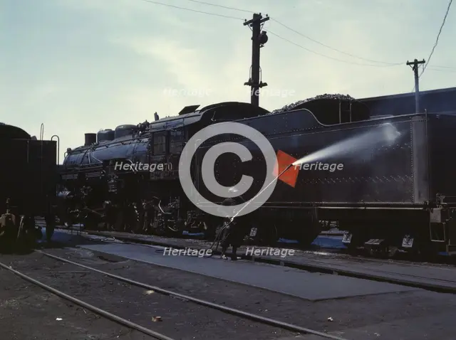 Cleaning an engine near the roundhouse, C. M. St. P. & P. R.R., Bensenville, Ill., 1943. Creator: Jack Delano.