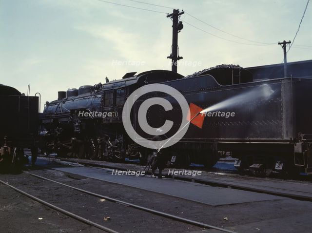 Cleaning an engine near the roundhouse, C. M. St. P. & P. R.R., Bensenville, Ill., 1943. Creator: Jack Delano.