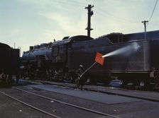 Cleaning an engine near the roundhouse, C. M. St. P. & P. R.R., Bensenville, Ill., 1943. Creator: Jack Delano