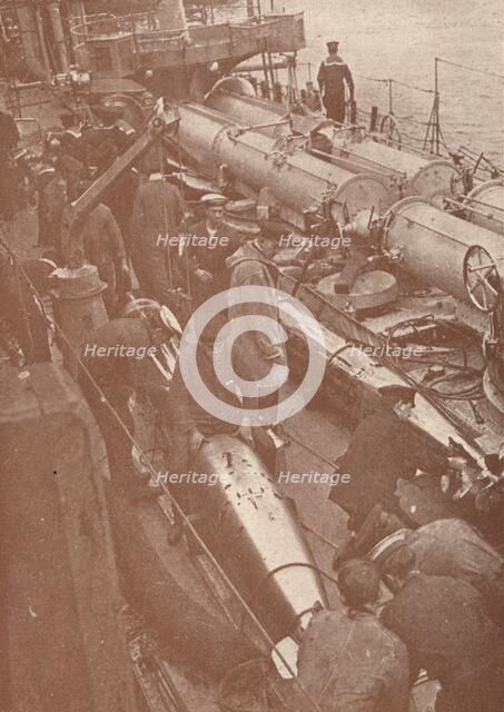 Cleaning and adjusting torpedoes, c1917 (1919). Artist: Unknown.