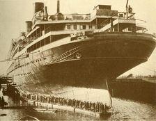 Cleaning the Hull of the "Majestic" in Dry Dock c1930. Creator: Unknown