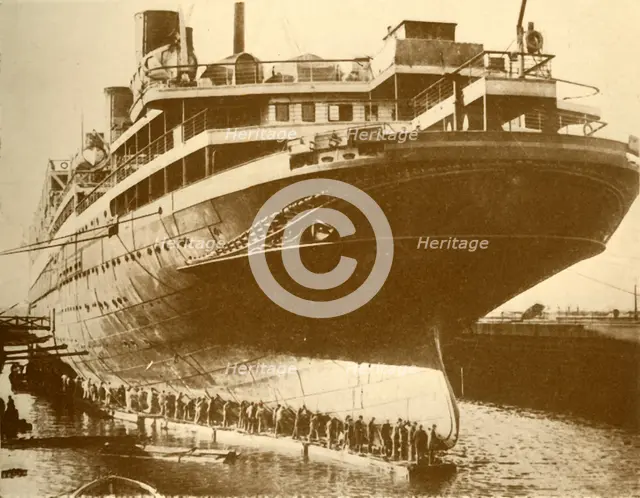 'Cleaning the Hull of the "Majestic" in Dry Dock', c1930. Creator: Unknown.