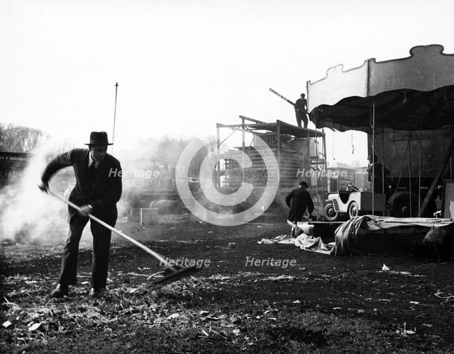 Cleaning up at Hampstead Funfair, April 1952. Creator: Henry Grant.