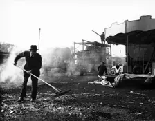 Cleaning up at Hampstead Funfair, April 1952. Creator: Henry Grant