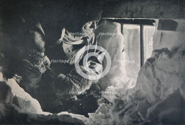 'Clearing Drift from Window of Hut at Cape Adare', c1911, (1913). Artist: G Murray Levick.