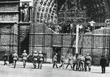 Clearing of sandbag protection from the facade of Notre Dame, German-occupied Paris, 1940