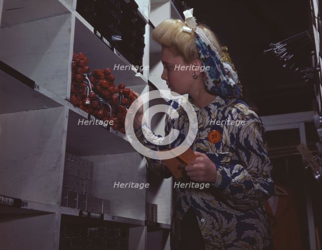 Clerk in one of the stock rooms of North American Aviation, Inc..., Inglewood, Calif. , 1942. Creator: Alfred T Palmer.