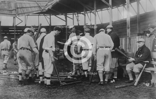 Cleveland [AL] ball players selecting new bats; Graney on bench, 1910. Creator: Bain News Service.