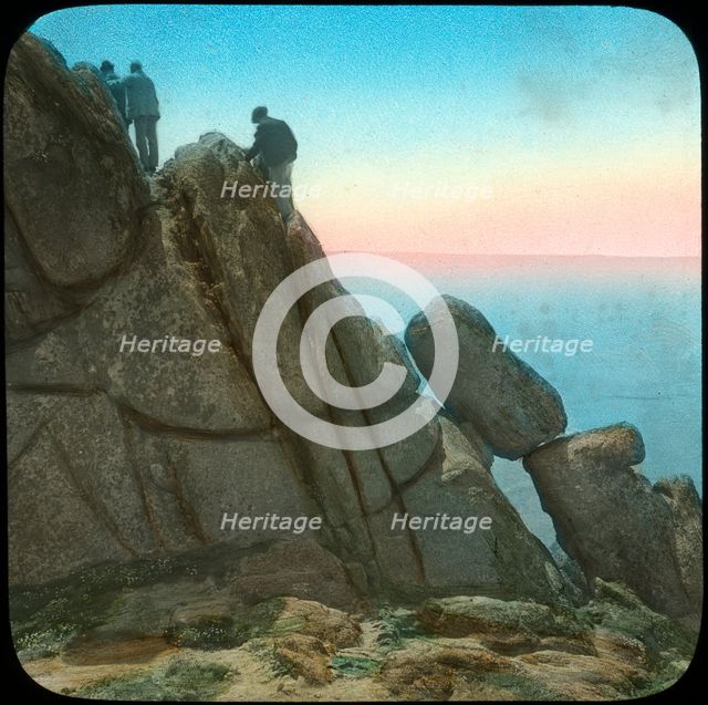 Climbing the Logan Rock, near Treen, Cornwall, late 19th or early 20th century.  Artist: Church Army Lantern Department