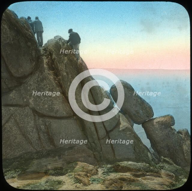 Climbing the Logan Rock, near Treen, Cornwall, late 19th or early 20th century.  Artist: Church Army Lantern Department