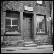 Clogs displayed in the window of H Greenwood Boot & Shoe Repairs shop, 1966-1974. Creator: Eileen Deste