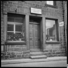 Clogs displayed in the window of H Greenwood Boot & Shoe Repairs shop, 1966-1974. Creator: Eileen Deste