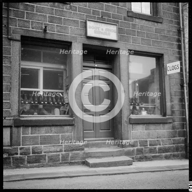 Clogs displayed in the window of H Greenwood Boot & Shoe Repairs shop, 1966-1974. Creator: Eileen Deste.