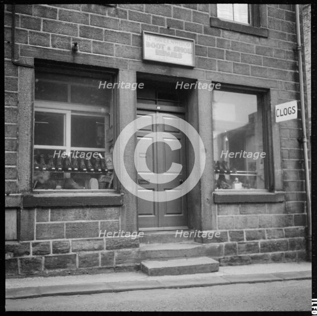 Clogs displayed in the window of H Greenwood Boot & Shoe Repairs shop, 1966-1974. Creator: Eileen Deste.