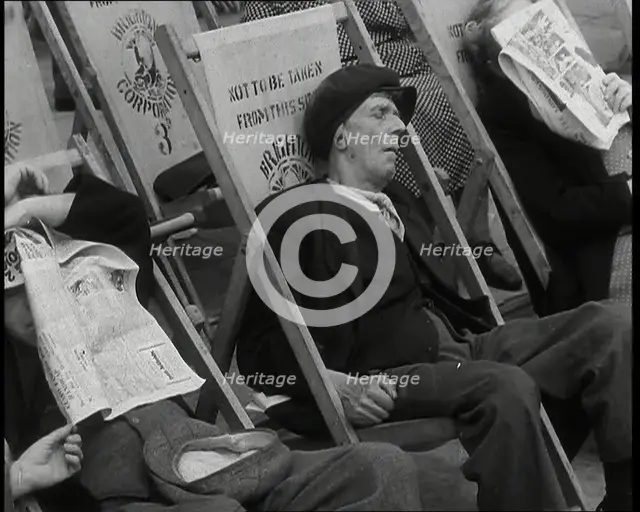 Close up on a Man in a Flat Cap and With a Neckerchief Sleeping in a Deck Chair on the Prom..., 1938 Creator: British Pathe Ltd.