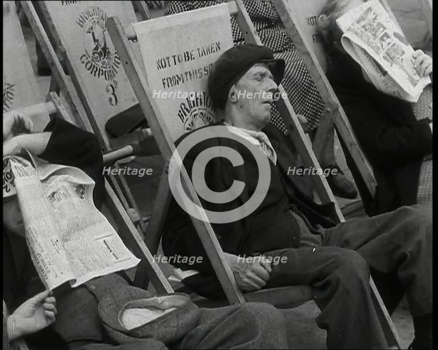 Close up on a Man in a Flat Cap and With a Neckerchief Sleeping in a Deck Chair on the Prom..., 1938 Creator: British Pathe Ltd.