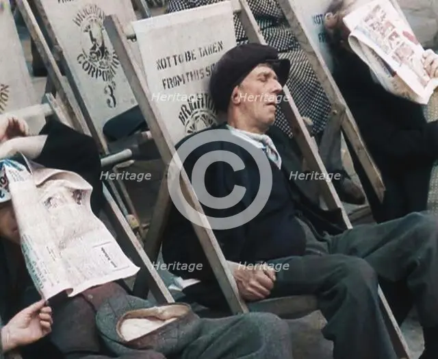 Close up on a Man in a Flat Cap and With a Neckerchief Sleeping in a Deck Chair on the Prom..., 1938 Creator: British Pathe Ltd.