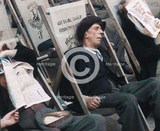 Close up on a Man in a Flat Cap and With a Neckerchief Sleeping in a Deck Chair on the Prom..., 1938 Creator: British Pathe Ltd.