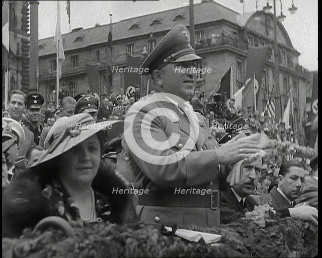 Close up of a German Nazi Party Official in a VIP Section of a Stand With Others Clapping..., 1938. Creator: British Pathe Ltd.