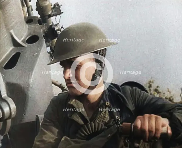 Close up of a Male British Soldier Wearing a Steel Helmet and Sitting Next to an Anti-Air..., 1939. Creator: British Pathe Ltd.