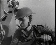 Close up of a Male British Soldier Wearing a Steel Helmet and Sitting Next to an Anti-Air..., 1939. Creator: British Pathe Ltd