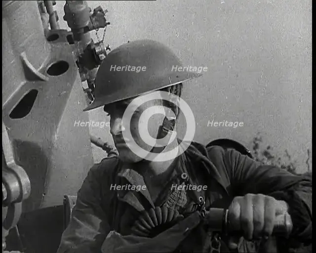 Close up of a Male British Soldier Wearing a Steel Helmet and Sitting Next to an Anti-Air..., 1939. Creator: British Pathe Ltd.