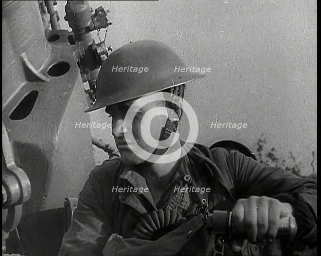 Close up of a Male British Soldier Wearing a Steel Helmet and Sitting Next to an Anti-Air..., 1939. Creator: British Pathe Ltd.