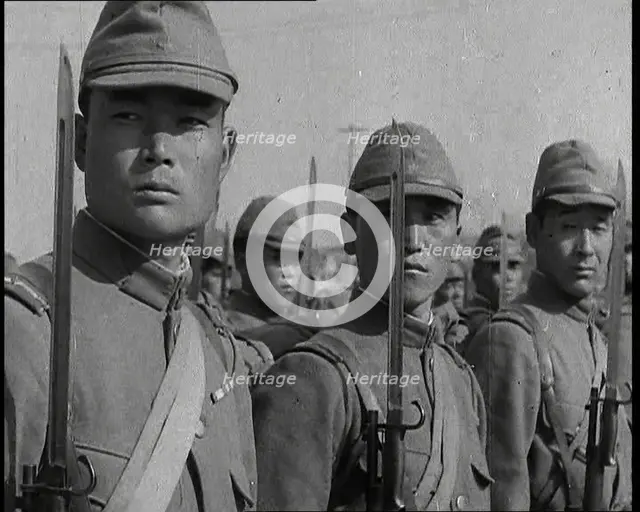 Close up of Male Japanese Soldiers Standing to Attention and Holding Their Bayonets Looking..., 1938 Creator: British Pathe Ltd.