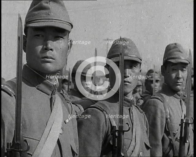Close up of Male Japanese Soldiers Standing to Attention and Holding Their Bayonets Looking..., 1938 Creator: British Pathe Ltd.