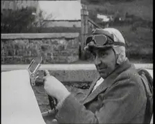 Close up Shot of John Godfrey Parry-Thomas Behind the Wheel of a Car Wearing a Racing Helmet, 1927. Creator: British Pathe Ltd