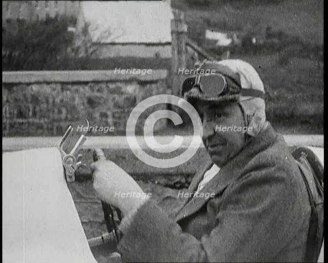 Close up Shot of John Godfrey Parry-Thomas Behind the Wheel of a Car Wearing a Racing Helmet, 1927. Creator: British Pathe Ltd.