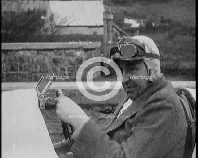 Close up Shot of John Godfrey Parry-Thomas Behind the Wheel of a Car Wearing a Racing Helmet, 1927. Creator: British Pathe Ltd.