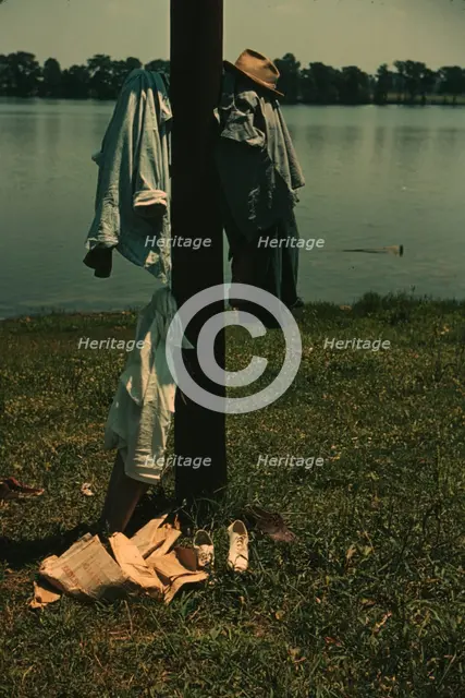 Clothes of swimmers hanging on a telegraph pole, Lake Providence, La., 1940. Creator: Marion Post Wolcott.
