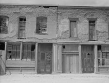 Crumbling buildings in Tombstone, Arizona, once a thriving mining town, 1937. Creator: Dorothea Lange