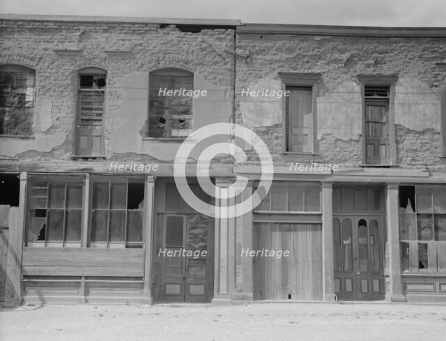 Crumbling buildings in Tombstone, Arizona, once a thriving mining town, 1937. Creator: Dorothea Lange.