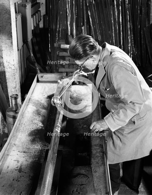 Crack detection on steel bars at J Beardshaw & Sons, Sheffield, South Yorkshire, 1963.  Artist: Michael Walters