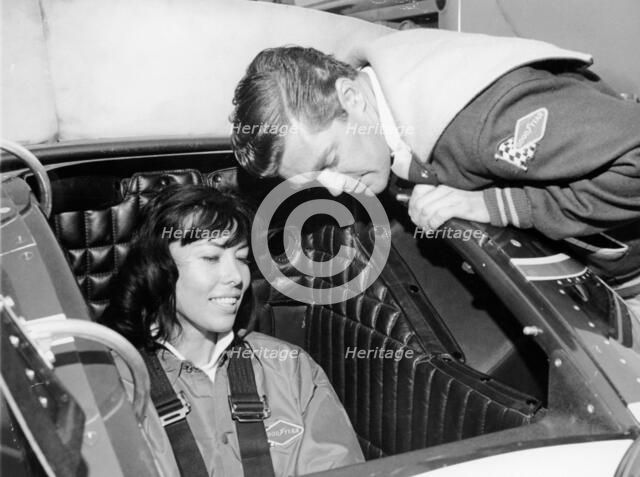 Craig Breedlove explaining the controls of 'Spirit of America Sonic I' to his wife, Lee, c1965. Artist: Unknown