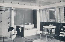 Crane Co. - A black, white, red and grey scheme wth an unglazed ceramic tile floor, oyster-white wa