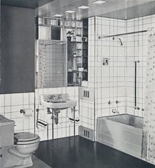 Crane Co. - A compact recess tiled in canary yellow, scored with orange, showing the stainless-stee