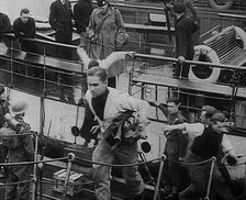 Crew of the Destroyed Bismarck Walking up a Gangplank Into a British Ship, 1943. Creator: British Pathe Ltd