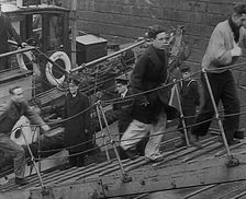Crew of the Destroyed Bismarck Walking up a Gangplank Into a British Ship, 1943. Creator: British Pathe Ltd