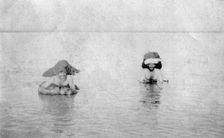 Crossing the Tigris river on inflated goat skins, 1918