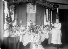 Crown Mother with Exhibit of Dolls, 1915. Creator: Harris & Ewing